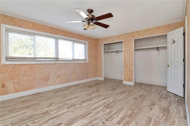 unfurnished bedroom with multiple windows, two closets, crown molding, and ceiling fan