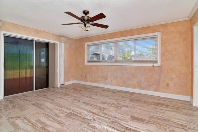 empty room featuring crown molding and ceiling fan