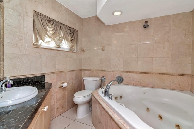 bathroom featuring toilet, tile walls, vanity, a relaxing tiled tub, and tile patterned flooring