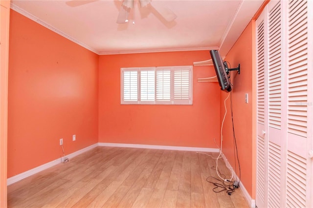 unfurnished bedroom featuring ceiling fan, ornamental molding, a closet, and light wood-type flooring