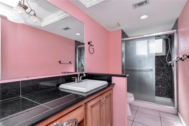 bathroom with crown molding, vanity, a shower with shower door, tile patterned floors, and toilet