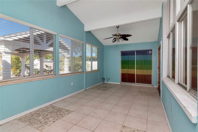 tiled empty room featuring ceiling fan and lofted ceiling with beams