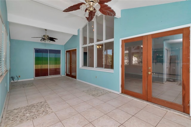 unfurnished sunroom featuring lofted ceiling with beams, ceiling fan, and french doors