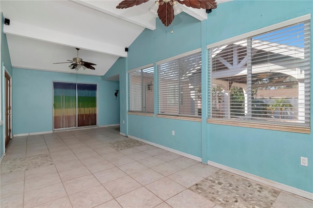 tiled spare room featuring ceiling fan, a healthy amount of sunlight, and lofted ceiling with beams