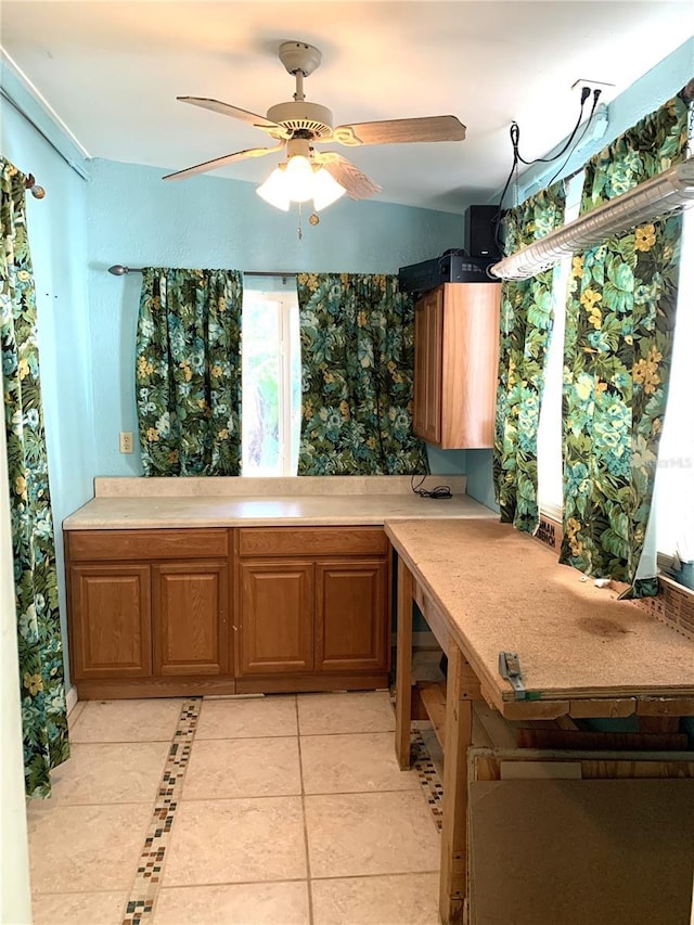 kitchen with ceiling fan and light tile patterned floors