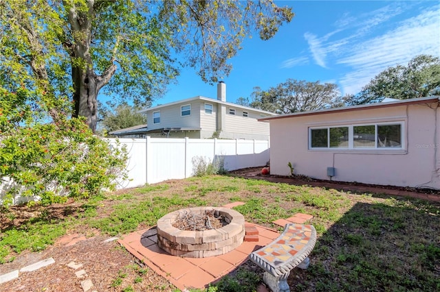 view of yard with an outdoor fire pit and a patio area