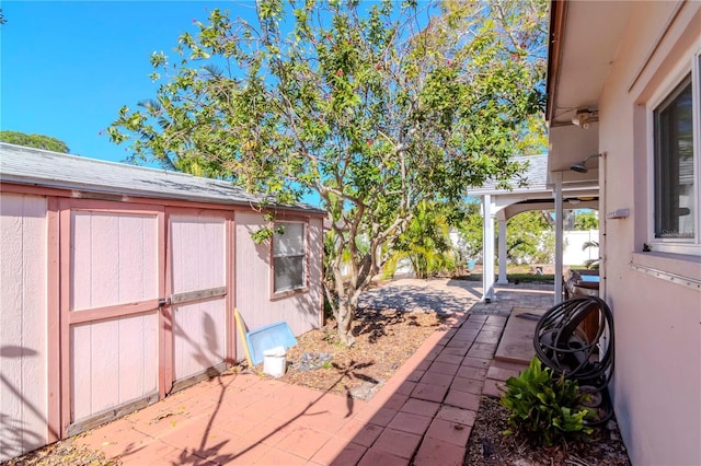 view of patio / terrace featuring a storage unit