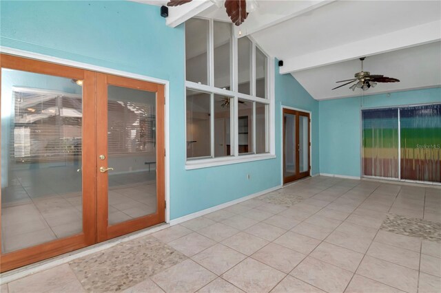 unfurnished room with french doors, ceiling fan, light tile patterned floors, and vaulted ceiling with beams