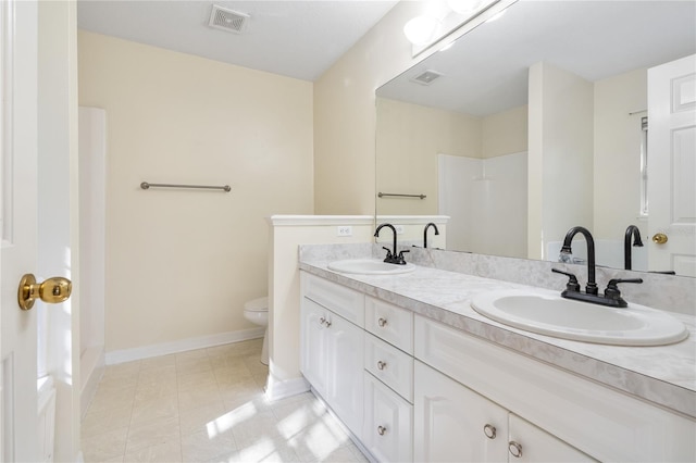 bathroom with vanity, a shower, and toilet