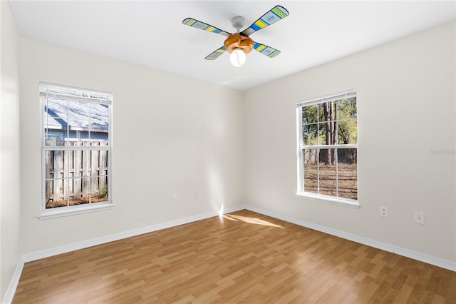 spare room with hardwood / wood-style floors and ceiling fan