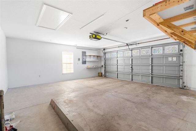 garage with a garage door opener and electric panel