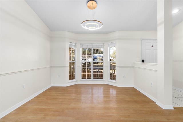 empty room with light hardwood / wood-style flooring