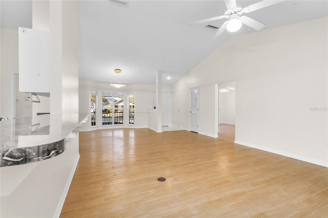 living room featuring high vaulted ceiling, light hardwood / wood-style floors, and ceiling fan