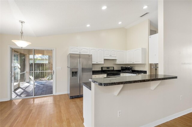 kitchen with pendant lighting, light hardwood / wood-style flooring, appliances with stainless steel finishes, white cabinets, and kitchen peninsula