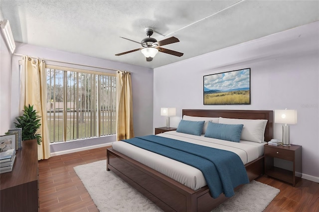 bedroom with ceiling fan and a textured ceiling