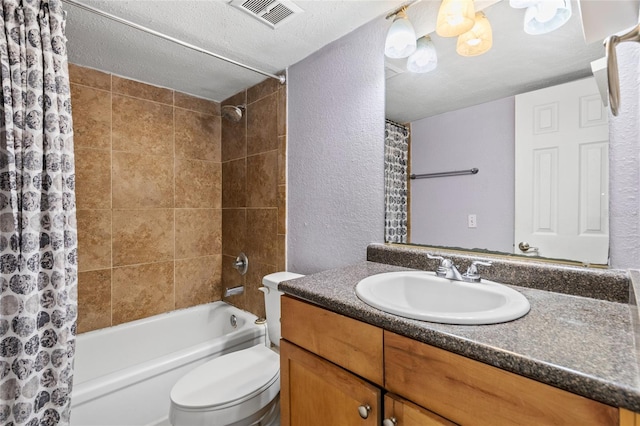 full bathroom with toilet, vanity, shower / bath combo, and a textured ceiling