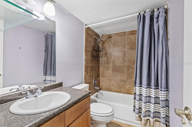 full bathroom featuring toilet, vanity, shower / bath combo with shower curtain, and a textured ceiling