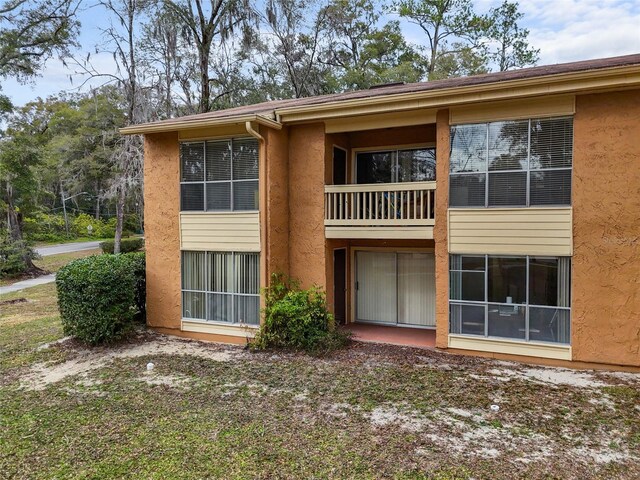 1810 NW 23rd Blvd Unit 202, Gainesville, FL 32605 - back of property with stucco siding and a balcony