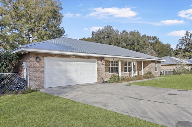 single story home with a garage and a front lawn