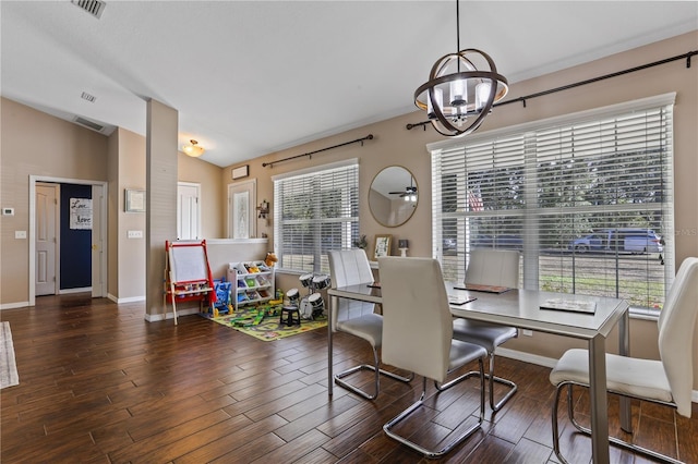 dining room featuring a chandelier, lofted ceiling, and dark hardwood / wood-style floors