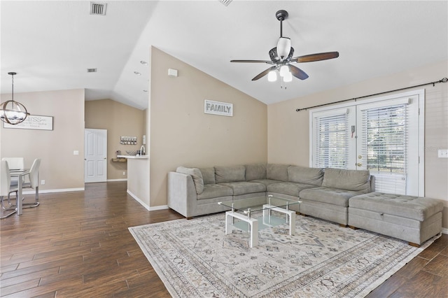 living room with vaulted ceiling and ceiling fan with notable chandelier