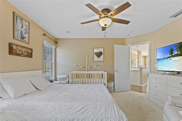 bedroom featuring light carpet and ceiling fan