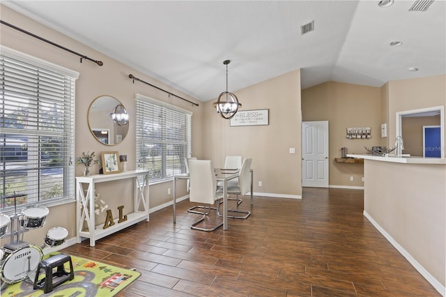 dining room featuring lofted ceiling, a wealth of natural light, and an inviting chandelier