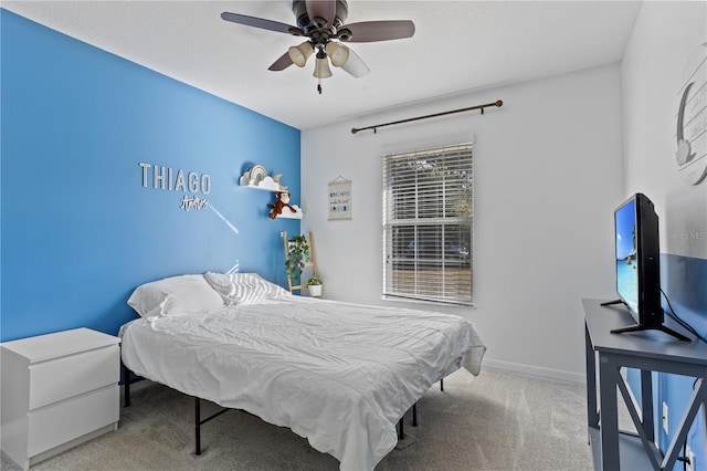 bedroom with ceiling fan and light carpet