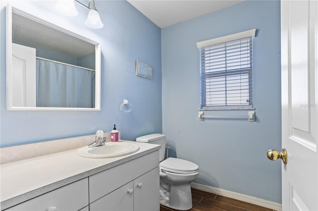 bathroom featuring toilet and vanity