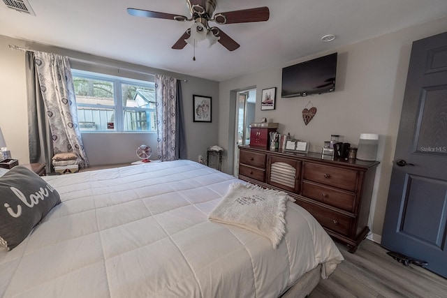 bedroom featuring ceiling fan and light hardwood / wood-style flooring