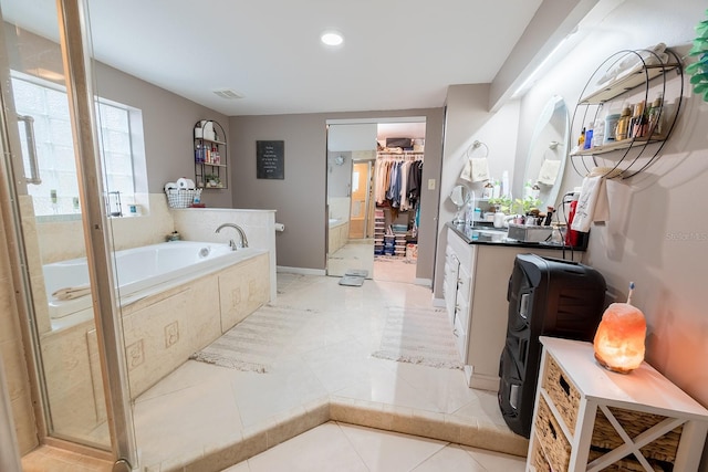 bathroom featuring plus walk in shower, tile patterned floors, and vanity