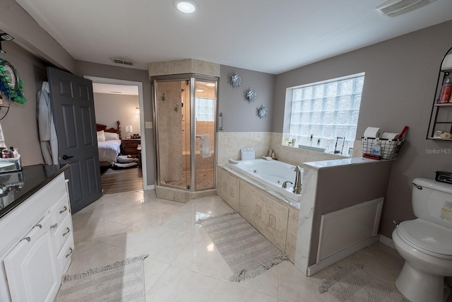 bathroom featuring toilet, separate shower and tub, and tile patterned flooring