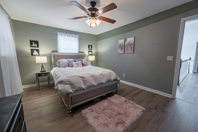 bedroom with ceiling fan and dark wood-type flooring