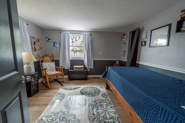 bedroom with light hardwood / wood-style flooring