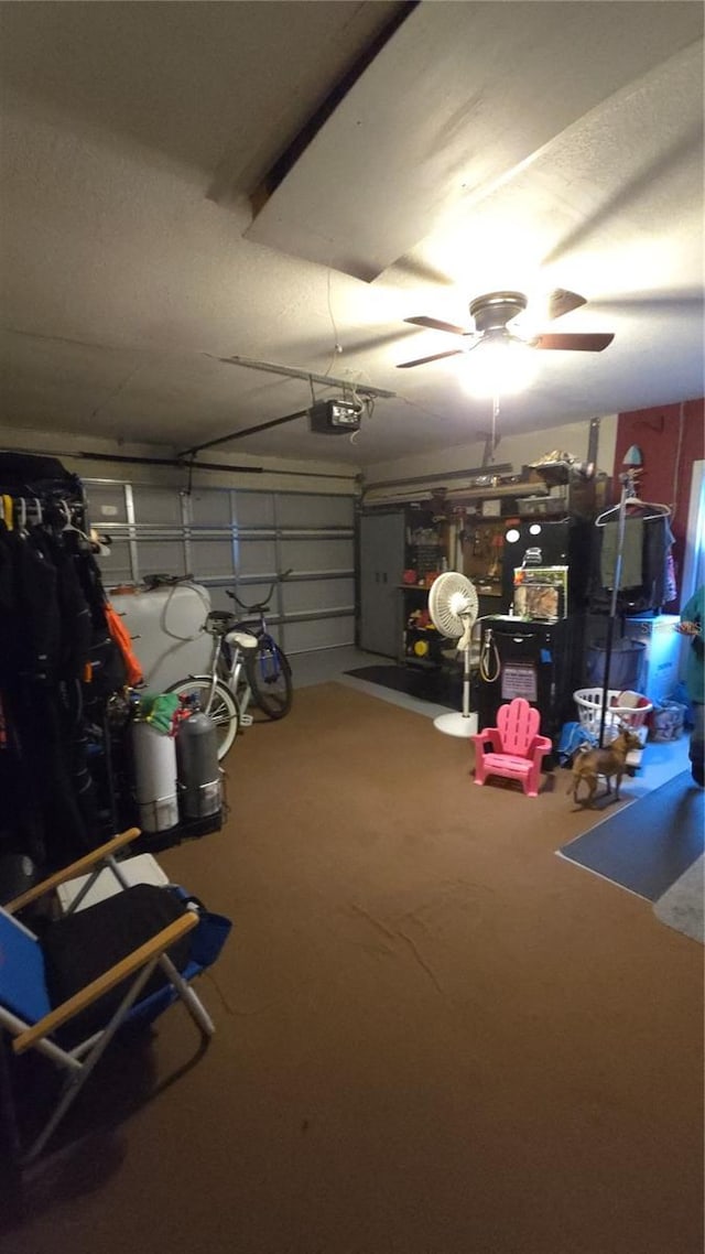 garage with a garage door opener and ceiling fan