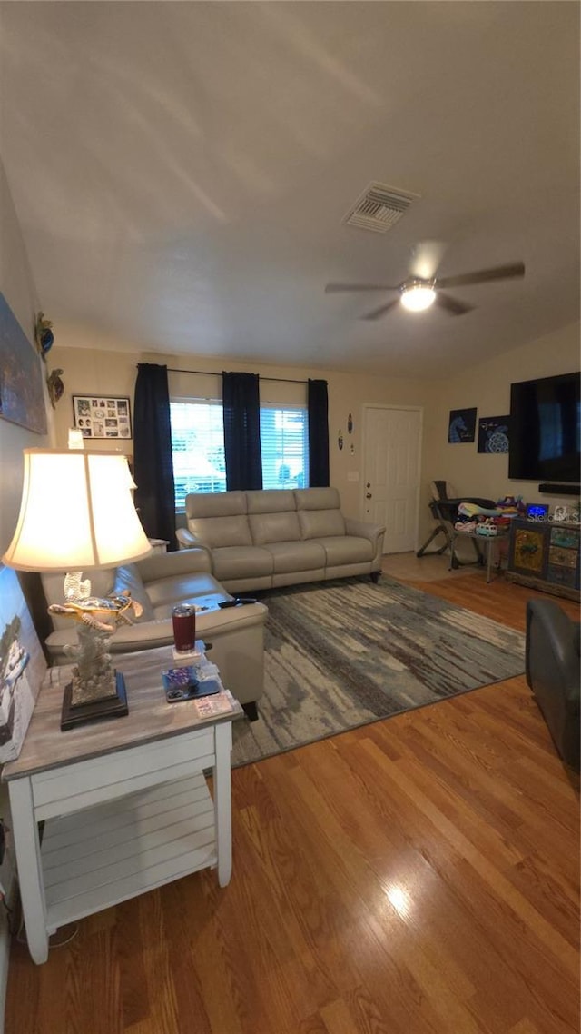 living room with hardwood / wood-style floors and ceiling fan