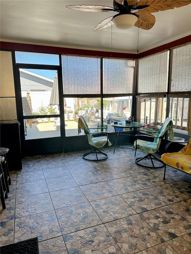 sunroom / solarium with ceiling fan