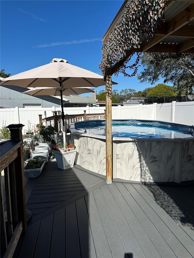 wooden deck featuring a fenced in pool