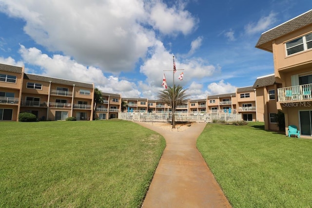 view of home's community featuring a lawn