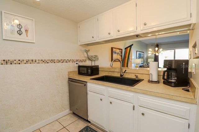 kitchen featuring stainless steel dishwasher, white cabinets, and sink