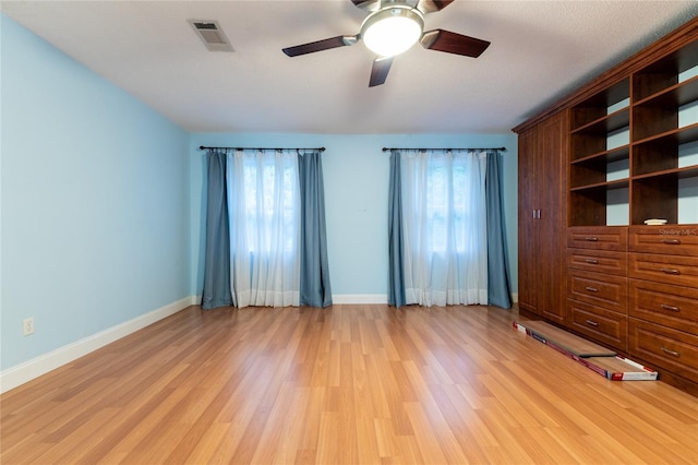 unfurnished room with ceiling fan, light hardwood / wood-style flooring, and a healthy amount of sunlight