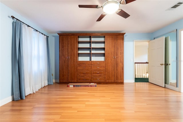 unfurnished bedroom with ceiling fan and light wood-type flooring