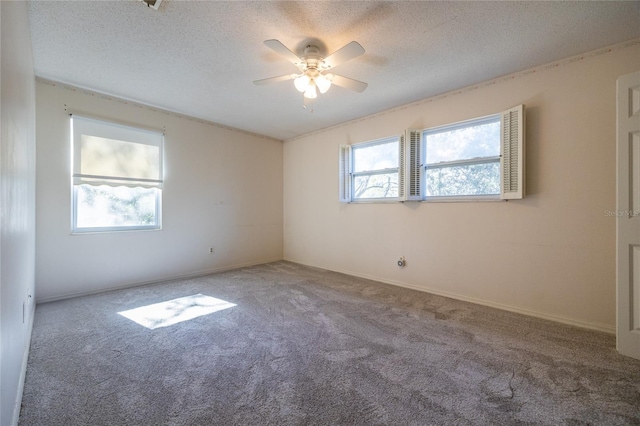 carpeted spare room featuring ceiling fan and a textured ceiling