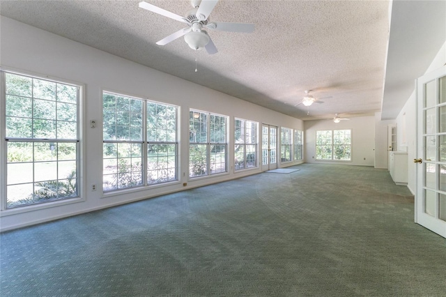 unfurnished sunroom with ceiling fan