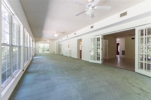 interior space with french doors and ceiling fan