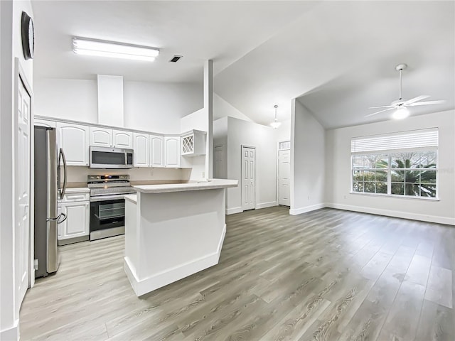 kitchen featuring ceiling fan, vaulted ceiling, light hardwood / wood-style floors, white cabinetry, and appliances with stainless steel finishes