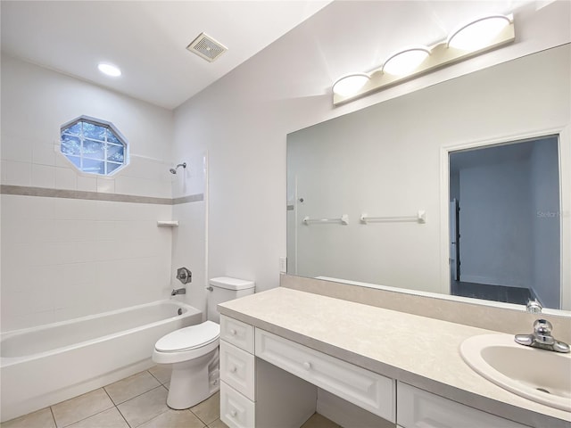 full bathroom featuring toilet, tiled shower / bath combo, tile patterned floors, and vanity