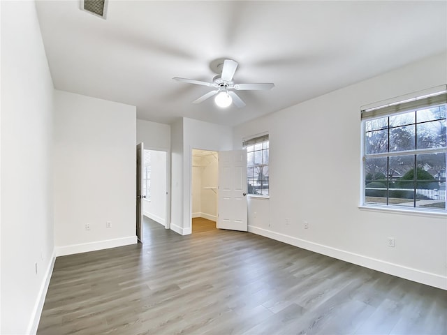 interior space with dark wood-type flooring and ceiling fan