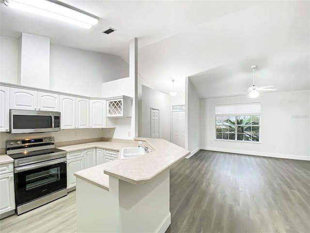 kitchen featuring white cabinets, appliances with stainless steel finishes, sink, kitchen peninsula, and ceiling fan