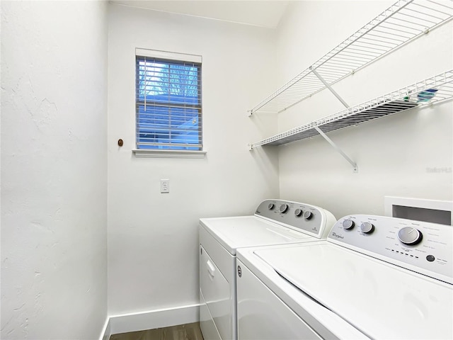 laundry room with washer and clothes dryer and wood-type flooring